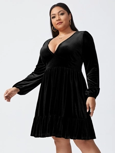Close-up of velvet fabric texture and ruffled hem detail on black plus size party dress