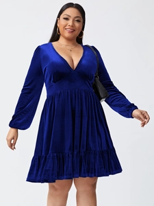 Detail of royal blue velvet plus size dress with V-neckline and tiered ruffle hem