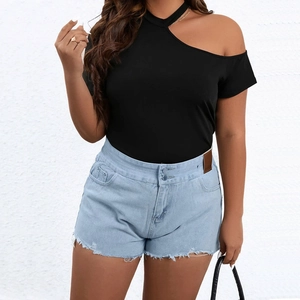 Women's off-shoulder black knit top paired with high-waisted frayed denim shorts