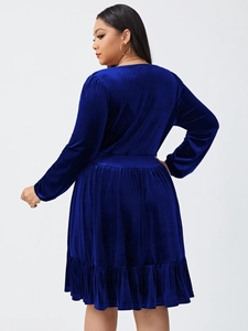 Detail of royal blue velvet fabric with waist pleats and ruffle hem on a party dress