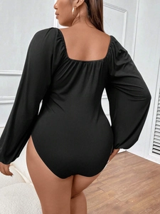 Slim fit black long sleeve bodysuit with square neck and puff sleeves shown from back view