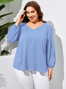 Light blue V-neck oversized blouse with pleated front and long lantern sleeves