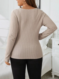 Detail view showing slim fit waffle knit texture on back of beige long sleeve V-neck top