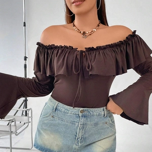 Detail of off-shoulder brown top featuring ruffled neckline and retro flared sleeves