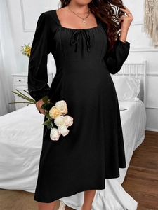 Elegant black square neck dress with lantern sleeves and lace-up front detail