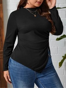 Black ribbed knit long sleeve top with an asymmetric hem and slimming side ruching details