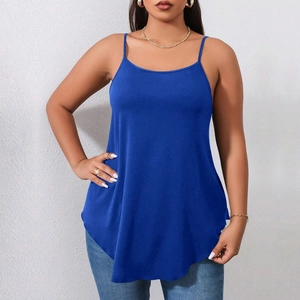 Detail of royal blue camisole with thin straps and curved hem on a model