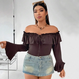 Detail of ruffle off-shoulder top with flared sleeves and distressed denim skirt