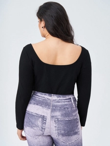 Slim fit black ribbed bodysuit with square neck and open back paired with purple denim pants