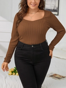 Detail shot of waffle knit texture on dark brown long sleeve shirt with square neckline
