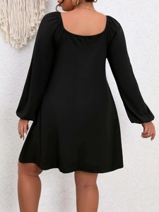 Plus size black A-line dress with puff sleeves and square neck seen from the back view