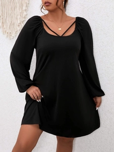 Plus size black A-line dress with lantern sleeves and decorative crisscross neckline