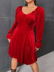 Plus size red velvet mini dress with sweetheart neckline and long puff sleeves