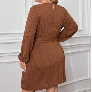 Back view of brown knitted A-line dress with drop-shaped button and waist tie detail