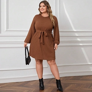 Detail of caramel knit dress featuring vertical rib texture and matching waist belt