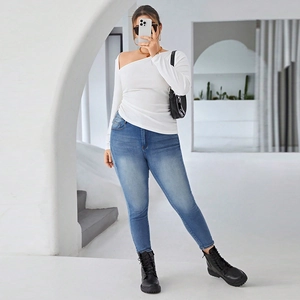 Slim fit off-shoulder long sleeve top with irregular pleats and blue skinny jeans
