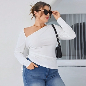 Detail of white ruched long sleeve top with asymmetric neckline and ribbed texture fabric