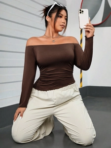 Women's brown off-shoulder long sleeve top paired with beige straight casual trousers