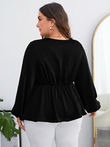 Elegant plus size black peplum blouse with long sleeves and elastic waist for women
