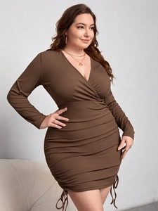 Detail of V-neck long sleeve dress featuring ribbed fabric texture and side ruched drawstrings