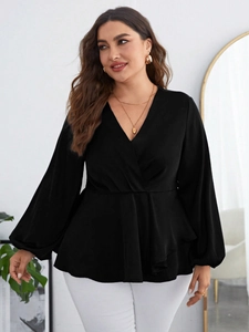 Detail of plus size black chiffon blouse featuring a crossover V-neck and peplum waist design