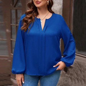 Close-up of royal blue V-neck long sleeve top with elegant lantern sleeves and soft fabric