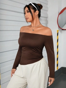 Detail of dark brown off-shoulder long sleeve top with slim fit ruched side design