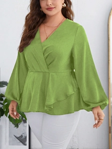 Detail of green V-neck chiffon blouse with peplum waist and puffy lantern sleeves