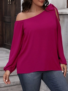 Detail of fuchsia off-shoulder blouse featuring a large bow on one shoulder