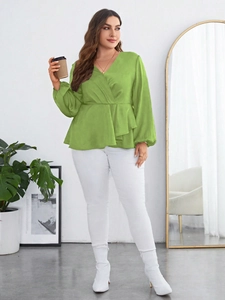 Detail of green chiffon blouse featuring deep V-neckline and stylish puff sleeves