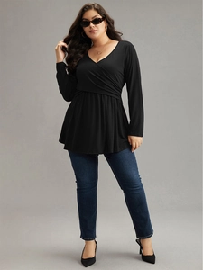 Elegant black long sleeve V-neck tunic with ruffled hem and slim fit waist design