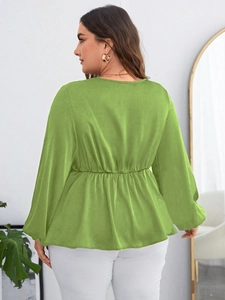 Detail of lime green chiffon blouse showing smocked waist and lightweight fabric texture