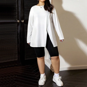 Detail of white oversized long sleeve T-shirt with unique side slit and asymmetric hemline