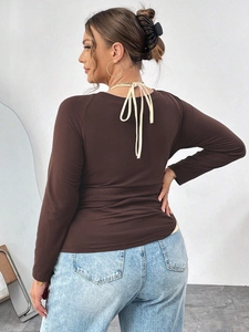 Slim-fit dark brown knit top with back tie-up bow detail and long sleeves for women