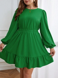 Elegant emerald green long sleeve dress with elastic waist and ruffled hemline