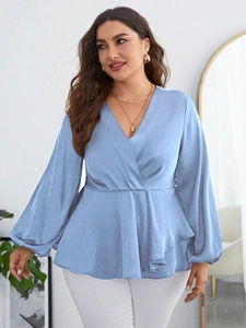 Detail of light blue V-neck chiffon blouse with puff sleeves and cinched waist texture