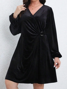 Elegant black velvet V-neck wrap dress with lantern sleeves and a silver waist buckle