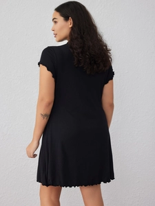 Elegant black short sleeve knit dress featuring lettuce edge trims and a slimming waist fit