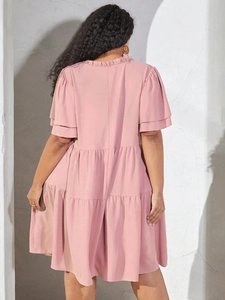 Pink V-neck tiered babydoll dress with ruffle sleeves and pleated layers, back view image