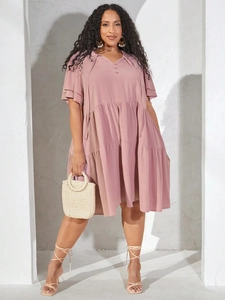 Detail of V-neck dusty pink dress showing tiered ruffle hem and double bell sleeves