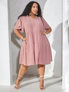 Detail of pink V-neck ruffle dress with tiered babydoll skirt and boho butterfly sleeves