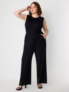Detail of black sleeveless wide leg jumpsuit with waist pleats and side pockets