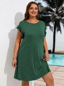 Plus size dark green A-line dress with ruffle sleeves shown by poolside outdoor