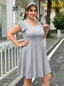 Plus size grey short sleeve mini dress with ruffle edges and ribbed knit fabric