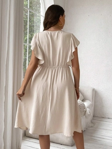 Beige mid-length dress with ruffle sleeves and elastic waist shown from the back view