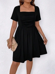 Detail view of the square neckline and pleated bust on a plus size black summer dress