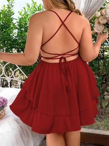 Deep red backless tiered maxi dress with thin criss-cross straps for summer vacation wear