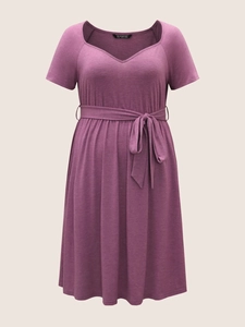 Detailed view of plus size V-neck dress featuring short sleeves and self-tie waist belt