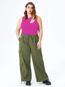 Detail view of the rose pink ribbed tank top with unique cutout design and cargo pants