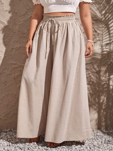 High-waisted beige wide leg trousers with drawstring elastic waist and side pockets